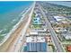 Beautiful coastal aerial view showcasing the beach, ocean, and cityscape with palm trees at 2071 S Atlantic Ave # 1005, Daytona Beach Shores, FL 32118