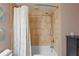 A tub and shower combination with a white shower curtain at 2071 S Atlantic Ave # 1005, Daytona Beach Shores, FL 32118