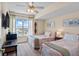 Bright guest bedroom featuring two twin beds, ceiling fan and a large window with a city view at 2071 S Atlantic Ave # 1005, Daytona Beach Shores, FL 32118
