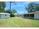 Expansive backyard featuring a large lawn, a shed, and a screened in lanai that enhances outdoor living at 241 Sanchez Ave, Ormond Beach, FL 32174