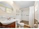 Bathroom featuring single sink, toilet and shower with glass shelving above toilet at 241 Sanchez Ave, Ormond Beach, FL 32174