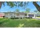 Charming single-story home featuring a well-maintained lawn, landscaping, and a screened garage at 241 Sanchez Ave, Ormond Beach, FL 32174