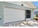 A white garage door offering security and curb appeal, complemented by stylish exterior at 241 Sanchez Ave, Ormond Beach, FL 32174
