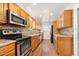 Efficient kitchen features stainless steel appliances and honey oak cabinets at 241 Sanchez Ave, Ormond Beach, FL 32174