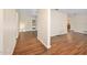 Open-concept living room with updated laminate wood flooring and neutral paint, seamlessly flowing into other living spaces at 241 Sanchez Ave, Ormond Beach, FL 32174