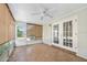 Bright sunroom with tile floors, a ceiling fan, and access to the outdoors at 241 Sanchez Ave, Ormond Beach, FL 32174