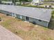Aerial view of the back of the townhome, showing landscaping, yard space, and rooftops at 244 Oakleigh Dr # 200, Deland, FL 32724