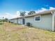 Exterior view of the backyard, featuring the home's siding, sliding glass door, and central AC unit at 244 Oakleigh Dr # 200, Deland, FL 32724