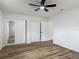 Bedroom with ceiling fan, and a closet with mirrored doors at 244 Oakleigh Dr # 200, Deland, FL 32724