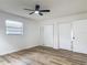 A bright bedroom with a ceiling fan and wood-look floors at 244 Oakleigh Dr # 200, Deland, FL 32724