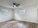 A spacious bedroom with two windows and wood-look flooring at 244 Oakleigh Dr # 200, Deland, FL 32724