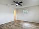 This bedroom features a ceiling fan and wood-look flooring at 244 Oakleigh Dr # 200, Deland, FL 32724