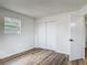 Well-lit bedroom featuring modern floors and a spacious closet at 244 Oakleigh Dr # 200, Deland, FL 32724
