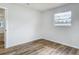 This bedroom features wood-look flooring, and a bright window at 244 Oakleigh Dr # 200, Deland, FL 32724