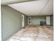 View of the covered carport area, showcasing the entrance door and ample space at 244 Oakleigh Dr # 200, Deland, FL 32724