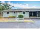Charming single-story home with light green siding, covered parking, and manicured front bushes at 244 Oakleigh Dr # 200, Deland, FL 32724