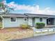 Charming single-story home with light green siding, covered parking, and manicured front bushes at 244 Oakleigh Dr # 200, Deland, FL 32724
