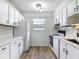 Well-lit kitchen with white cabinets, modern appliances, and ample countertop space at 244 Oakleigh Dr # 200, Deland, FL 32724