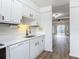 Kitchen with white cabinetry and a view into the living area at 244 Oakleigh Dr # 200, Deland, FL 32724