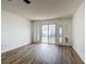 Spacious living room with new flooring, neutral paint, ceiling fan and slider to backyard at 244 Oakleigh Dr # 200, Deland, FL 32724
