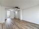 Spacious living room with new flooring leading into the kitchen, and neutral paint at 244 Oakleigh Dr # 200, Deland, FL 32724