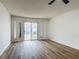 Bright, open living room features vinyl flooring, and sliding glass doors leading to backyard at 244 Oakleigh Dr # 200, Deland, FL 32724