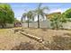 This backyard features a fire pit, privacy fence, and a storage shed at 2468 Scottville Ave, Deltona, FL 32725