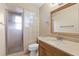Well-lit bathroom with a stand-up shower, tiled walls, and a solid surface vanity at 2468 Scottville Ave, Deltona, FL 32725