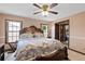 Large bedroom with dual windows, a ceiling fan and a luxurious king-sized bed at 2468 Scottville Ave, Deltona, FL 32725