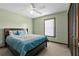 Comfortable bedroom with a ceiling fan, carpet, and a large bed with blue accents at 2468 Scottville Ave, Deltona, FL 32725