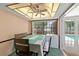 Cozy dining room with natural light, ceiling fan, and access to a pool view through the sliding doors at 2468 Scottville Ave, Deltona, FL 32725