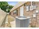 Backyard view with A/C unit, brick exterior, and well-maintained yard at 2468 Scottville Ave, Deltona, FL 32725