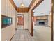 Inviting hallway view leading to a living room with a brick fireplace feature at 2468 Scottville Ave, Deltona, FL 32725