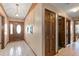 Hallway featuring paneled doors and tiled floors leading to other rooms in the home at 2468 Scottville Ave, Deltona, FL 32725