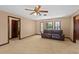 Spacious living room showcasing a ceiling fan, and a comfortable sofa near the bright windows at 2468 Scottville Ave, Deltona, FL 32725
