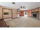 The living room features a carpet finish, ceiling fan, and brick fireplace at 2468 Scottville Ave, Deltona, FL 32725