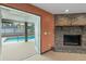 Inviting living room with brick fireplace and french doors leading to screened-in pool at 2468 Scottville Ave, Deltona, FL 32725