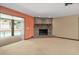 Comfortable living room featuring a brick fireplace, neutral decor, and access to the screened-in pool area at 2468 Scottville Ave, Deltona, FL 32725