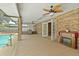 The patio features a ceiling fan, fireplace, access to the pool and ample space at 2468 Scottville Ave, Deltona, FL 32725