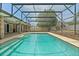 A screened-in swimming pool that features a brick deck and privacy fence at 2468 Scottville Ave, Deltona, FL 32725
