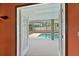 View of the pool and backyard from inside the home through French doors at 2468 Scottville Ave, Deltona, FL 32725
