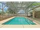 The screened-in pool offers refreshing turquoise waters, steps, and a large patio for enjoyment and entertainment at 2468 Scottville Ave, Deltona, FL 32725