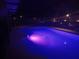 Backyard pool with integrated lighting creating a serene and inviting nighttime ambiance at 2468 Scottville Ave, Deltona, FL 32725