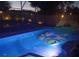 Enjoy this relaxing backyard pool at night, with landscape lighting and an inflatable float at 2468 Scottville Ave, Deltona, FL 32725