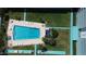 Bird's-eye view of community pool, lounge chairs, and lush landscaping around condominium buildings at 2727 N Atlantic Ave # 602, Daytona Beach, FL 32118