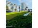 Well-maintained green lawn and walkways, and lush green landscaping around the condominium building at 2727 N Atlantic Ave # 602, Daytona Beach, FL 32118
