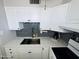 Modern kitchen with white cabinets, stone countertops, and stainless steel appliances at 2727 N Atlantic Ave # 602, Daytona Beach, FL 32118