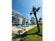 Beautiful, sparkling condominium swimming pool surrounded by tropical landscaping and resort building at 2727 N Atlantic Ave # 602, Daytona Beach, FL 32118
