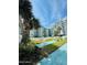 Beautiful resort pool with deck seating, surrounded by lush tropical greenery and condominium building at 2727 N Atlantic Ave # 602, Daytona Beach, FL 32118