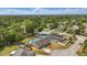 Aerial view of a charming neighborhood with houses, pools, and lush greenery in a serene setting at 290 Greenwood Cir, Ormond Beach, FL 32174